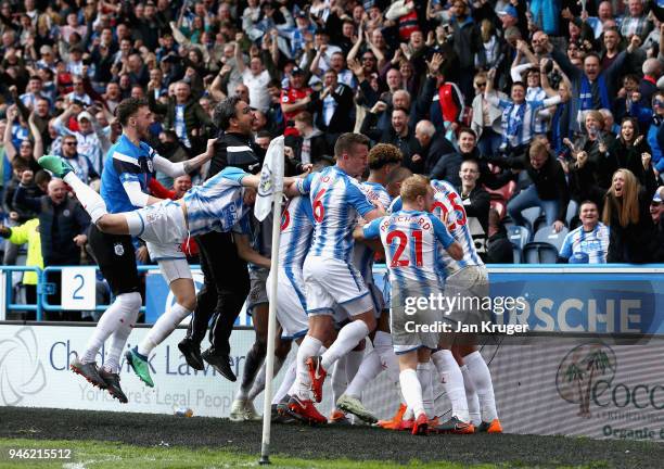 Tom Ince of Huddersfield Town celebrates with teammates and his manager, David Wagner after scoring his sides first goal during the Premier League...