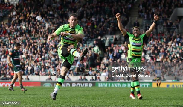 Stephen Myler of Northampton Saints clears the ball to touch to win the match as Luther Burrell celebrates during the Aviva Premiership match between...