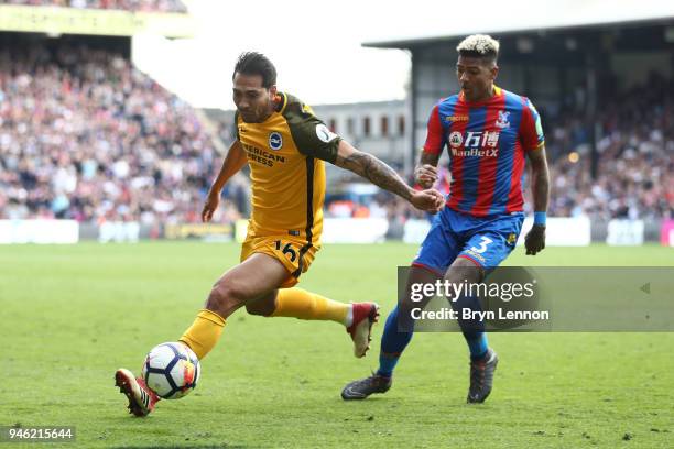 Leonardo Ulloa of Brighton and Hove Albion is challenged by Patrick van Aanholt of Crystal Palace during the Premier League match between Crystal...