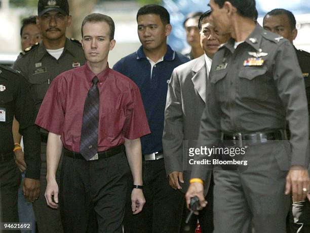 American teacher John Mark Karr, second from left, is escorted by Thai police officers during his deportation from the Immigration Detention Center...