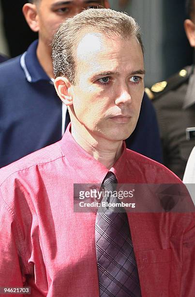 American teacher John Mark Karr is escorted by Thai police officers during his deportation from the Immigration Detention Center in Bangkok,...