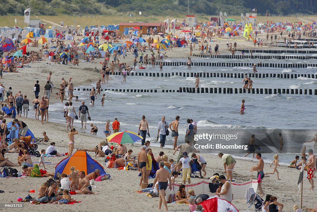 Beachgoers enjoy the sun and surf at Warnemuende beach in Ro