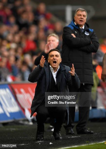 Everton manager Sam Allardyce looks on as Swansea manager Carlos Carvalhal reacts during the Premier League match between Swansea City and Everton at...