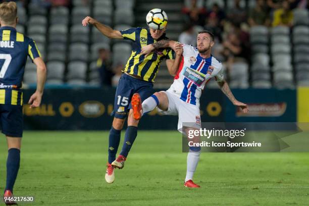 Central Coast Mariners defender Alan Baro heads the ball under pressure from Newcastle Jets forward Roy ODonovan at the A-League Soccer Match between...