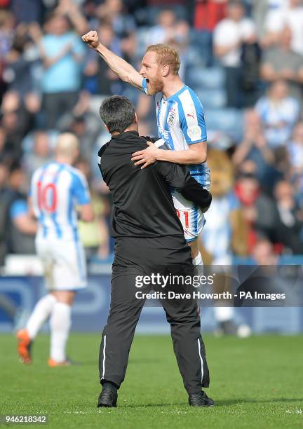 Huddersfield Town's Alex Pritchard celebrates the victory with manager David Wagner after the Premier League match at the John Smith's Stadium,...