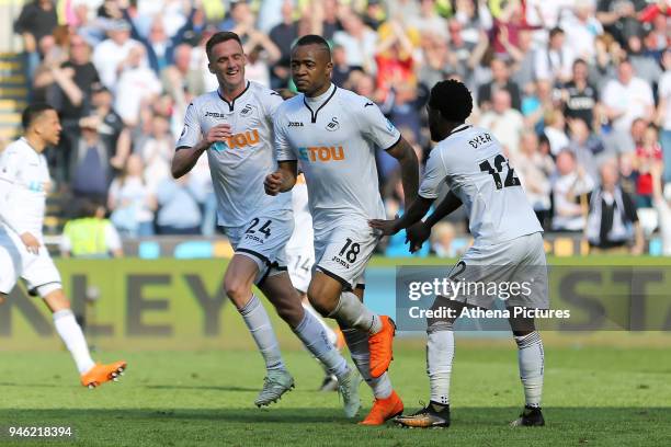 Jordan Ayew of Swansea City celebrates his goal with team mates Andy King of and Nathan Dyer during the Premier League match between Swansea City and...