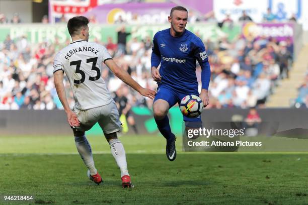 Wayne Rooney of Everton gets with the ball past Joel Robles of Everton during the Premier League match between Swansea City and Everton at The...