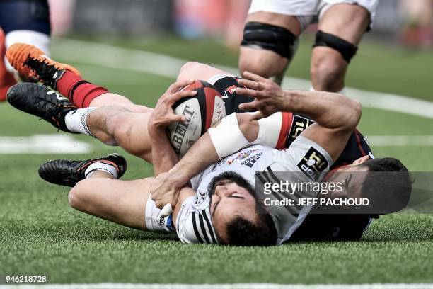 Brive's French scrumhalf Samuel Marques is tackled by Oyonnax' French centre Maxime Veau during the French Top 14 rugby union match US Oyonnax vs CA...