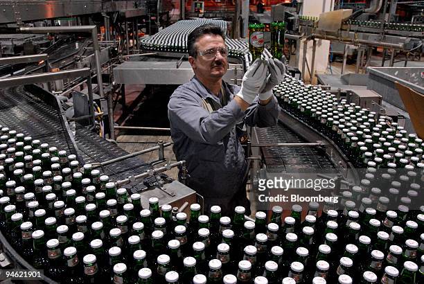 Worker checks bottles of Kronenbourg beer at the company's brewery in Obernay, France, on Tuesday, Dec. 18, 2007. Carlsberg A/S Chief Executive...