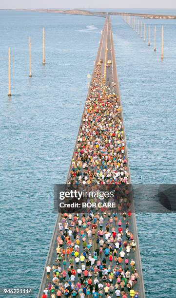 In this aerial photo provided by the Florida Keys News Bureau, about 1,500 runners fan out over Florida Keys waters during the Seven Mile Bridge Run...