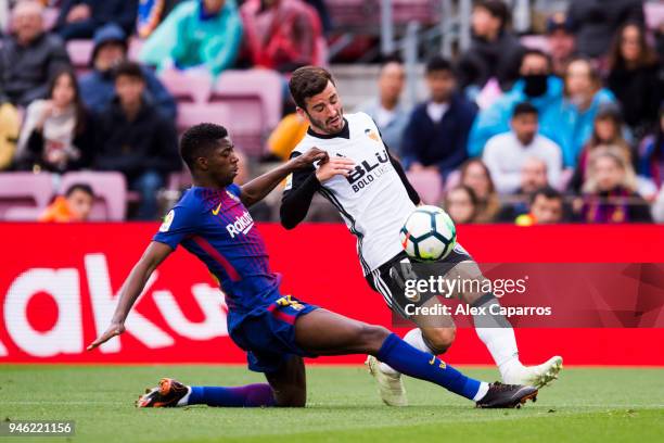 Ousmane Dembele of FC Barcelona fouls Jose Gaya of Valencia CF inside the penalty box during the La Liga match between Barcelona and Valencia at Camp...