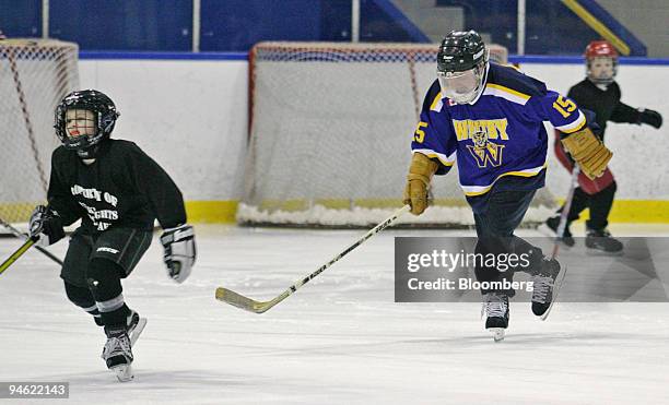 Canadian Finance Minister Jim Flaherty skates on the ice with kids to promote the Children's Fitness Tax Credit in Whitey, Ontario on Friday, January...