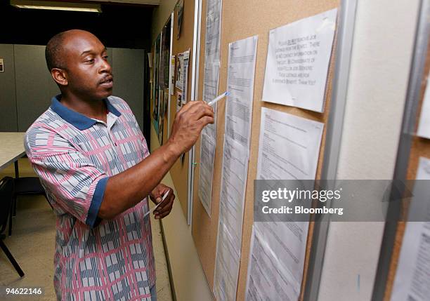 William Rankin checks the job postings board at the St. Louis Agency on Training & Employment center in St. Louis, Missouri Friday, June 2, 2006....