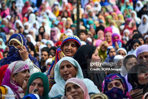 Kashmiri Muslim women pray upon seeing a relic believed to be hair from the beard of Prophet Muhammad on the occasion of the Islamic festival...