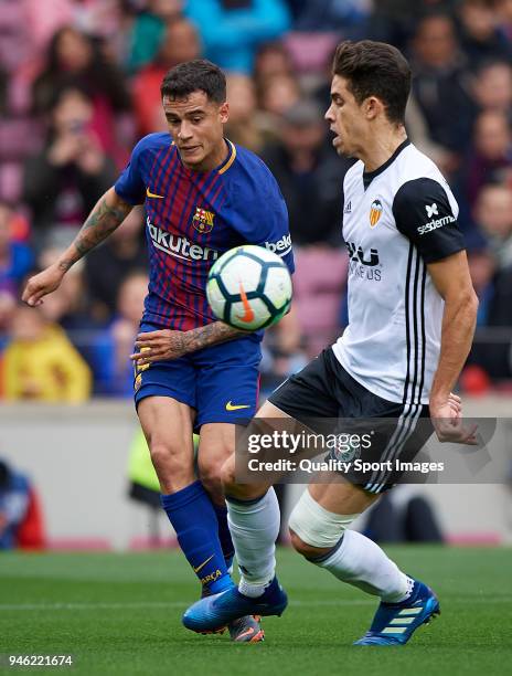 Philippe Coutinho of Barcelona competes for the ball with Gabriel Paulista of Valencia during the La Liga match between Barcelona and Valencia at...