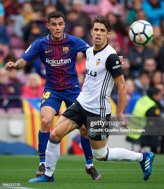 Philippe Coutinho of Barcelona competes for the ball with Gabriel Paulista of Valencia during the La Liga match between Barcelona and Valencia at...