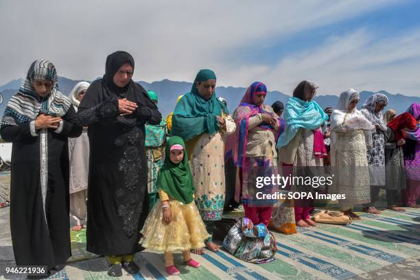 Kashmiri Muslims offer noon prayers on the occasion of the Islamic festival Shab-e-Meraj at Hazratbal Shrine in Srinagar, Indian administered...