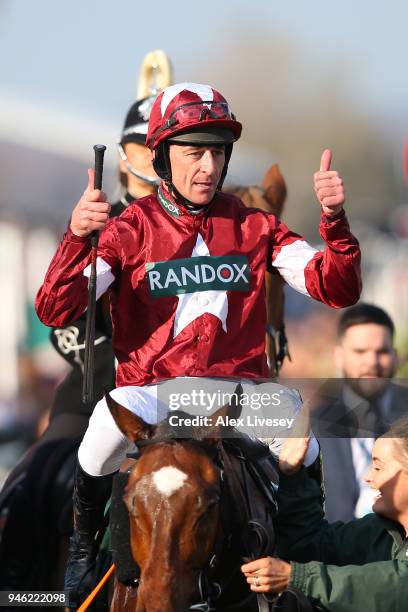 Davy Russell celebrates after riding Tiger Roll to victory during the 2018 Randox Health Grand National at Aintree Racecourse on April 14, 2018 in...