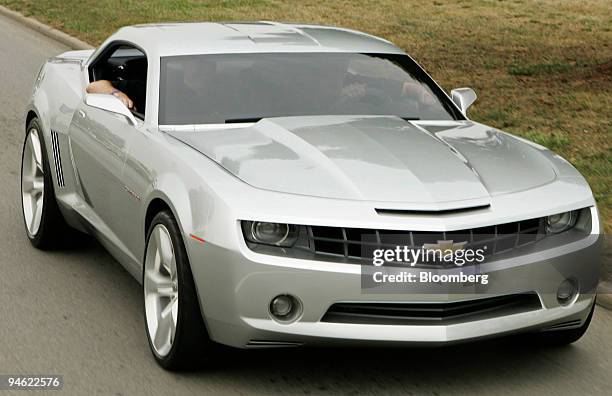 Rick Wagoner, chairman and chief executive officer of General Motors Corp., drives the Chevrolet Camaro concept vehicle down Woodward Ave. As part of...