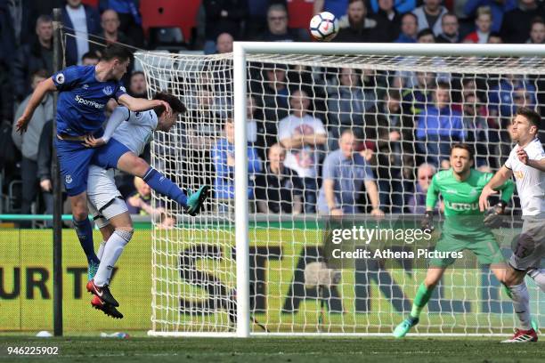 Michael Keane of Everton heads the ball over Ki Sung-Yueng of Swansea City during the Premier League match between Swansea City and Everton at The...