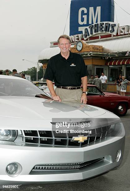 Rick Wagoner, chairman and chief executive officer of General Motors Corp., poses with the Chevrolet Camaro concept vehicle after driving it down...