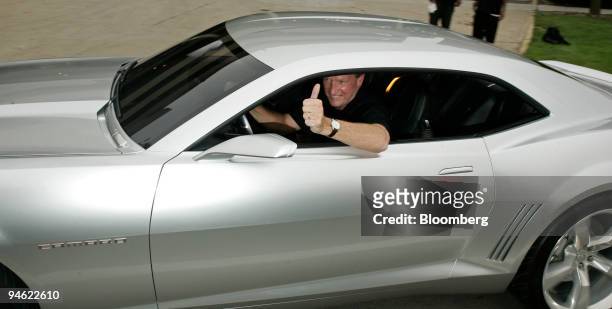 Rick Wagoner, chairman and chief executive officer of General Motors Corp., drives the Chevrolet Camaro concept vehicle down Woodward Ave. As part of...