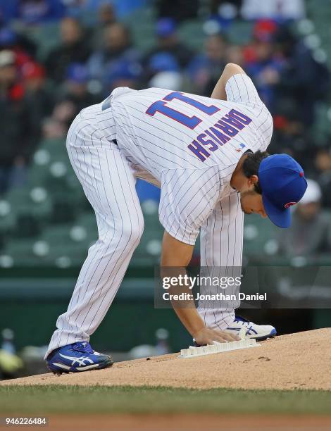 Starting pitcher Yu Darvish of the Chicago Cubs uses the rosin bag during a game against the Atlanta Braves at Wrigley Field on April 13, 2018 in...