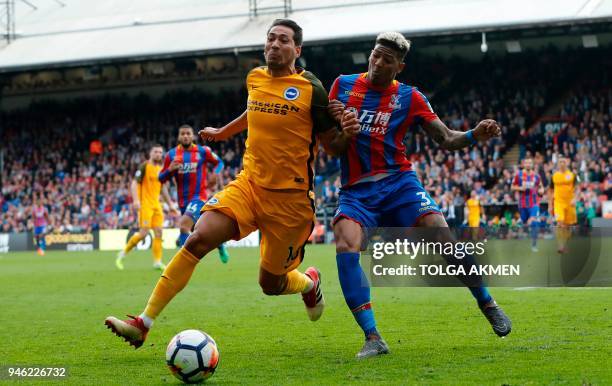 Brighton's Argentinian striker Leonardo Ulloa battles with Crystal Palace's Dutch defender Patrick van Aanholt during the English Premier League...