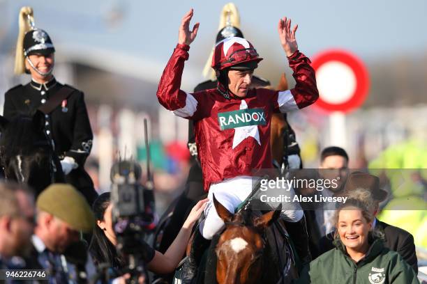 Davy Russell celebrates after riding Tiger Roll to victory during the 2018 Randox Health Grand National at Aintree Racecourse on April 14, 2018 in...