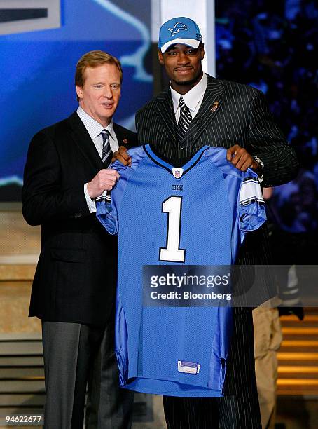 Roger Goodell, commissioner of the National Football League, left, poses with Calvin Johnson, former wide receiver with Georgia Tech University,...