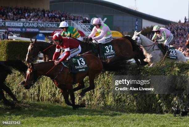 Tiger Roll ridden by Davy Russell jump the Water Jump on their way to victory in the Randox Health Grand National Handicap Steeple Chase at Aintree...