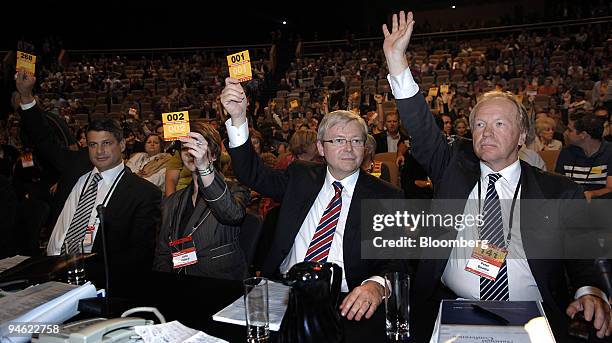 Members of Australia's Labor Party raise their hands during a vote over a ban on uranium mines at the Australian Labor Party National Conference, in...