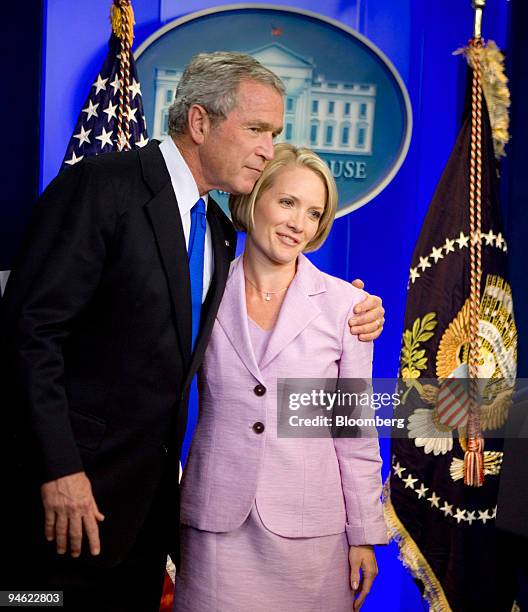 President George W. Bush hugs White House deputy press secretary Dana Perino after White House press secretary Tony Snow announced he is resigning...