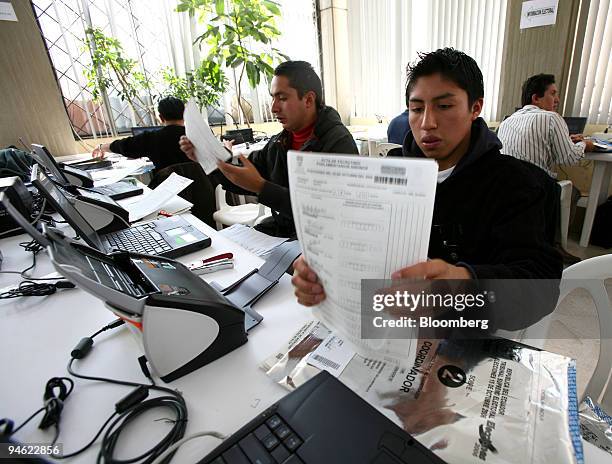 People at the TSE, Tribunal Supremo Electoral, scan the votes of E Vote which counted the votes of the Presidential elections on Sunday in Quito,...