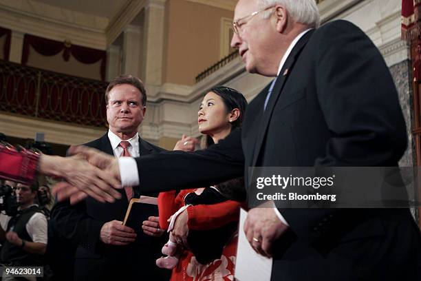 Freshman Senator Jim Webb of Virginia, his wife Hong-Le Webb holding their daughter Georgia Webb and Vice President Dick Cheney participate in the...