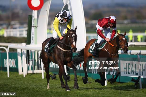 Davy Russell rides Tiger Roll to victory, closely followed by David Mullins riding Pleasant Company during the Randox Health Grand National Handicap...