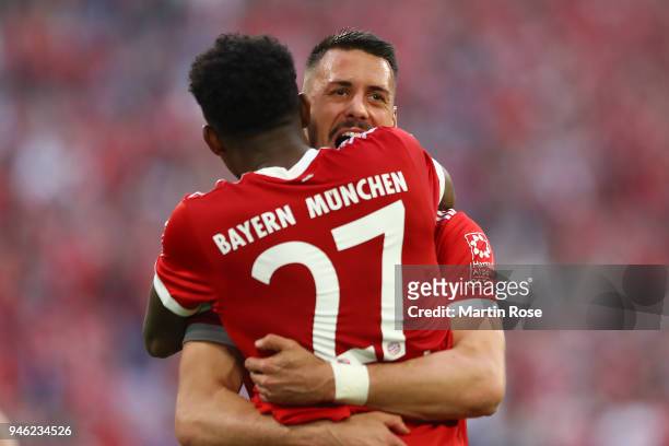 Sandro Wagner of Muenchen celebrates with David Alaba of Bayern Muenchen after he scored a goal to make it 2:1 during the Bundesliga match between FC...