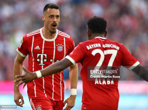 Sandro Wagner of Muenchen celebrates with David Alaba of Bayern Muenchen after he scored a goal to make it 2:1 during the Bundesliga match between FC...