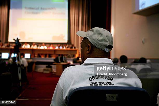An election observer oversees the proceedings at the vote counting centre in Maseru, Lesotho on Sunday, Feb. 18, 2007. Voters in the southern African...