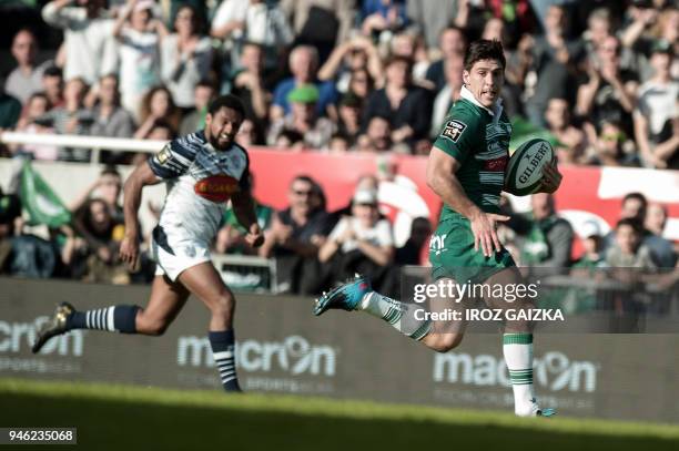 Pau's French scrum-half Thibault Daubagna runs to score a try during the French Top 14 rugby union match between Pau and Agen at the Hameau stadium...