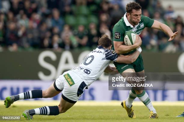 Pau's New-Zealander fullback Tom Taylor is tackled by Agen's french fly-half Thomas Vincent during the French Top 14 rugby union match between Pau...