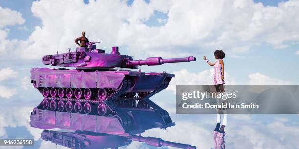 woman stands before purple tank driven by man - ungerechtigkeit stock-fotos und bilder