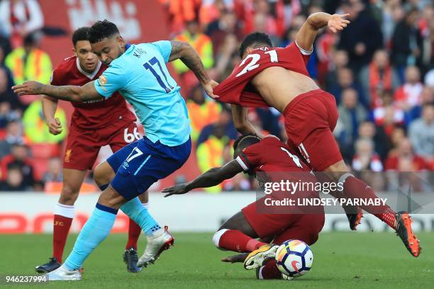 Bournemouth's Norwegian striker Joshua King vies with Liverpool's English midfielder Alex Oxlade-Chamberlain and Liverpool's Senegalese midfielder...