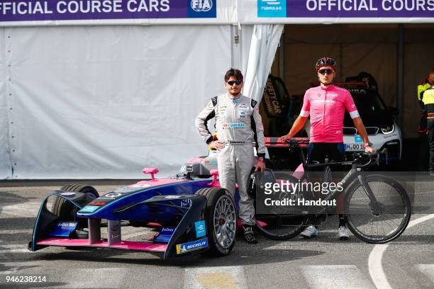 In this handout provided by FIA Formula E, Cyclist Gianni Moscon and Racing driver, Giancarlo Fisichella, with the Formula E track car. During the...