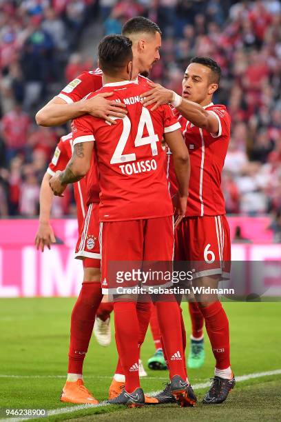 Thiago Alcantara of Bayern Muenchen celebrates with Sandro Wagner of Muenchen and Tolisso of Bayern Muenchen after he scored a goal to make it 3:1...