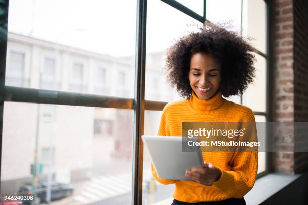 smiling woman using digital tablet. - business casual stock pictures, royalty-free photos & images