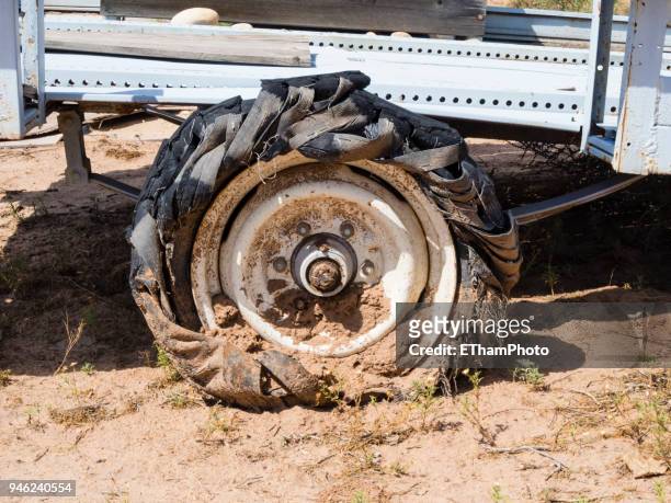 rusty abandoned truck wreck with deflated blowout tire - tyre side view foto e immagini stock