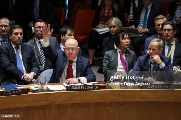 Russian Ambassador to the United Nations Vasily Nebenzya votes yes for a Russian proposed draft resolution that would "condemn the aggression against...