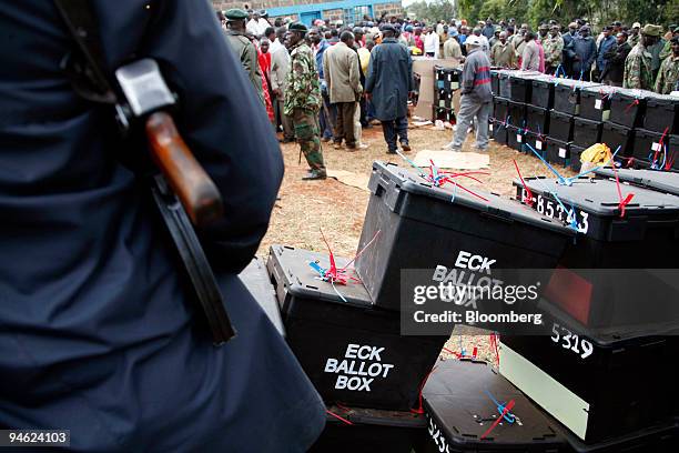 Policeman guards ballot boxes at the Kajiado North constituency polling station after rumors of the boxes being stuffed with unofficial votes spread...