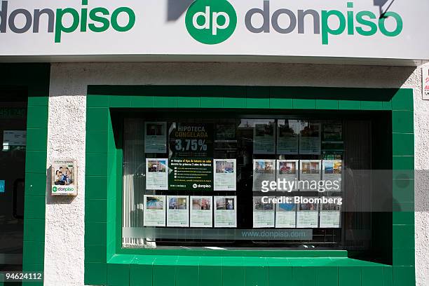Signs advertising real estate for sale are posted in the window of the Don Piso estate agents in Madrid, Spain, on Tuesday, Sept. 18, 2007. The sign...